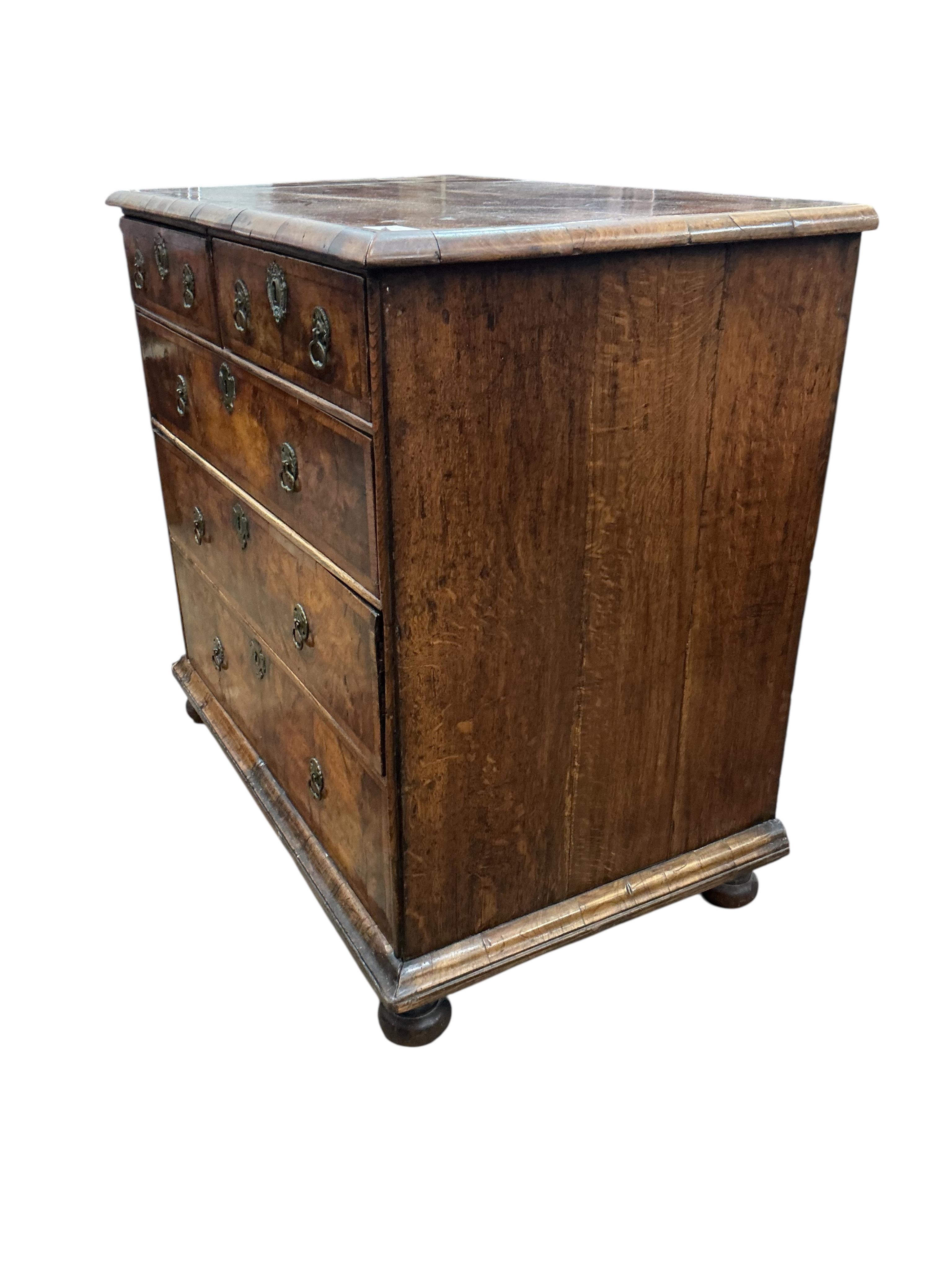 A Queen Anne walnut chest, with bun feet, width 92cm, depth 55cm, height 86cm